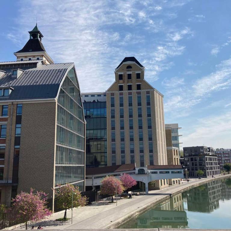 a group of buildings next to a body of water at Joyau de Pantin in Pantin