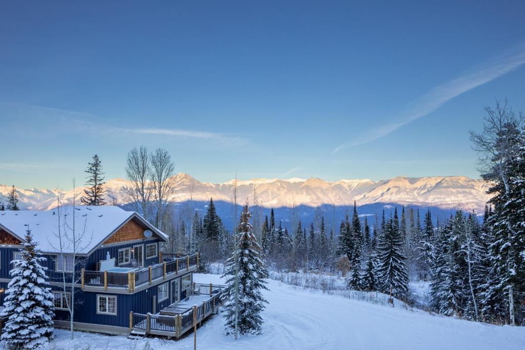 una casa en la nieve en las montañas en Lush Mountain Accommodations en Golden