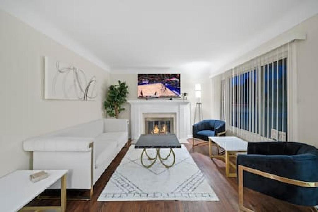 a living room with a couch and a fireplace at Stylish Luxury 3bd home in Downtown Birmingham in Birmingham
