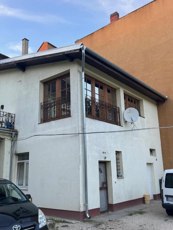 a white house with a basketball hoop in front of it at Fantomas Apartments*** TH 32.1 - 3 Bedroom+Living room Apartments in Szombathely