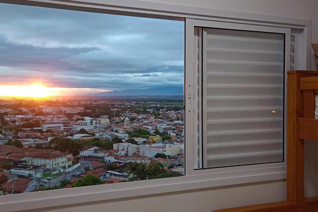 a window with a view of a city at Apartamento em Cachoeira Pta in Cachoeira Paulista