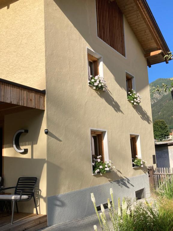 a building with flower boxes on the windows at paclera79 in Santa Maria Val Müstair