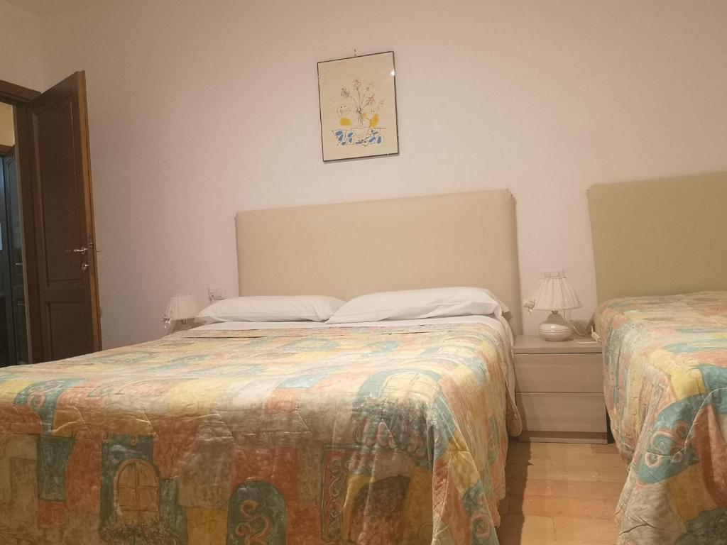 a bedroom with two beds in a room at Il Gelsomino in Foligno