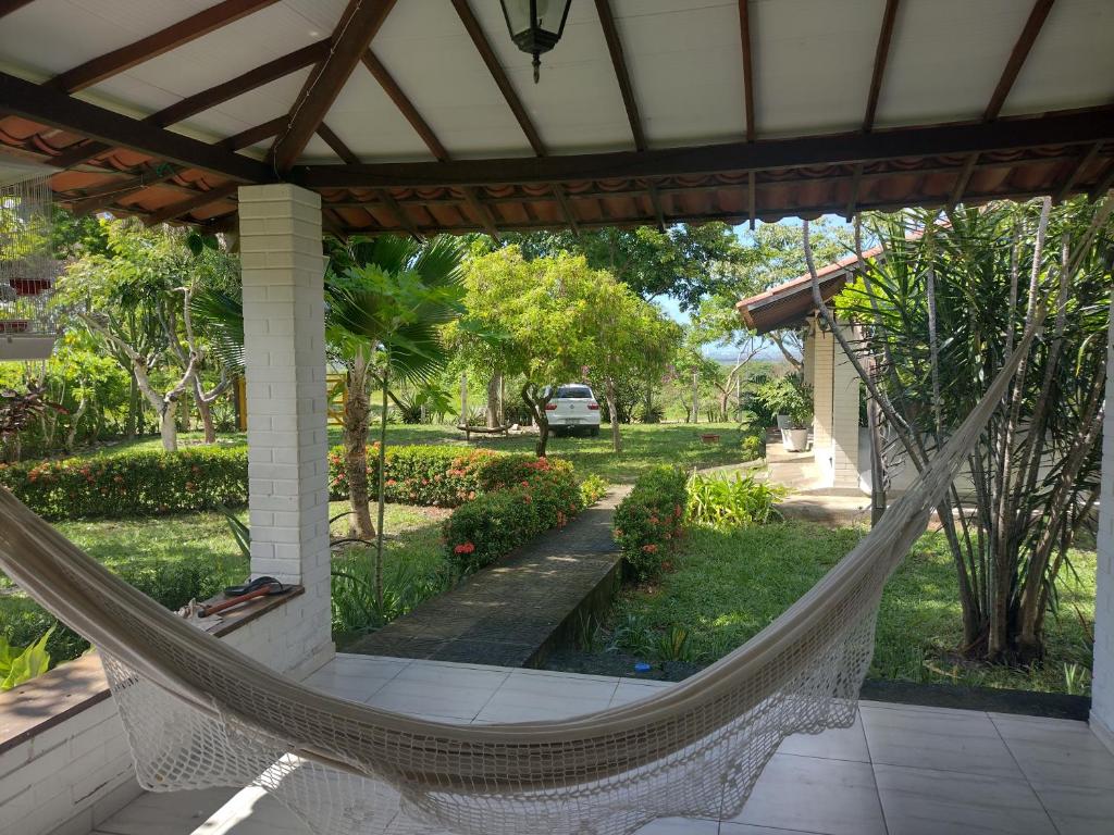 a hammock on the porch of a house at Casa de campo, perto da praia in Lucena