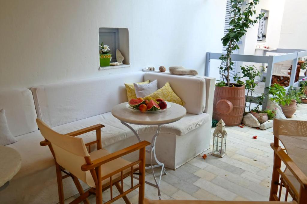 a living room with a couch and a table with fruit on it at Sanoudos in Naxos Chora