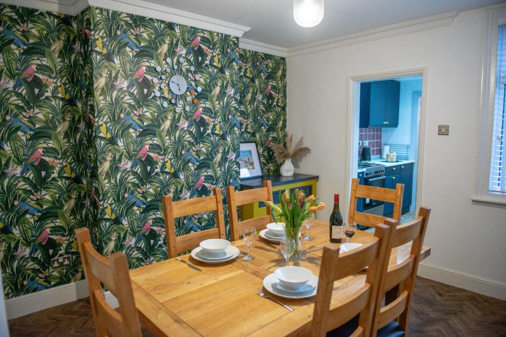 a dining room with a wooden table and chairs at The Limes - Stylish City Centre Retreat in Peterborough