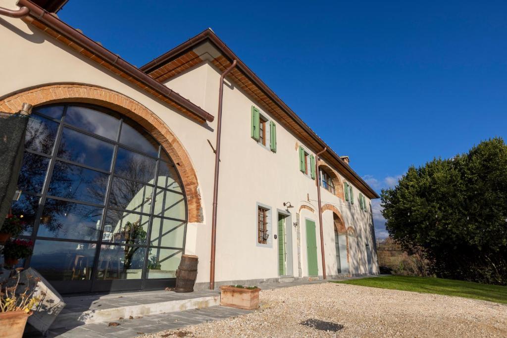 a building with a large window on the side of it at Podere La Casella in Galliano