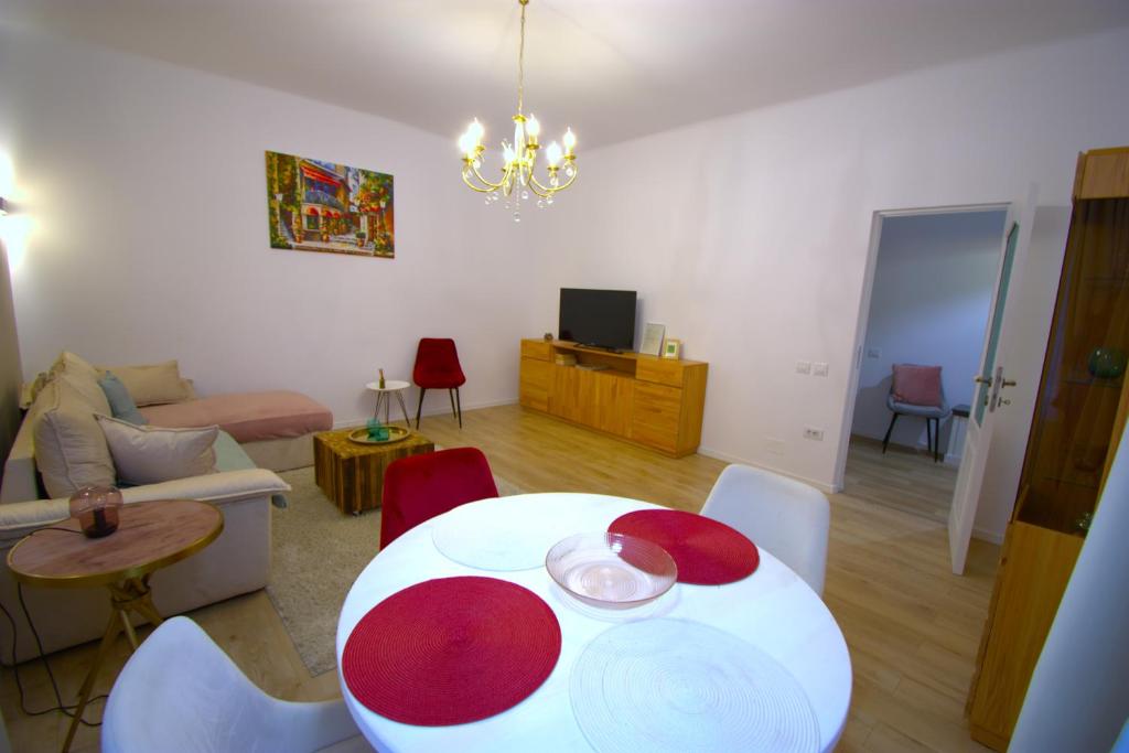 a living room with a table and a couch at Homey Luxury- entire house, free parking, yard in Cluj-Napoca