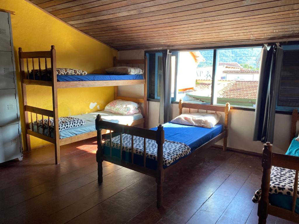 a room with two bunk beds and a window at Casa Lee Hostel in Paraty