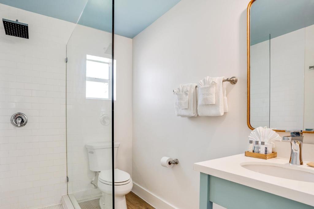 a white bathroom with a sink and a toilet at Fisher Inn Resort & Marina in Islamorada