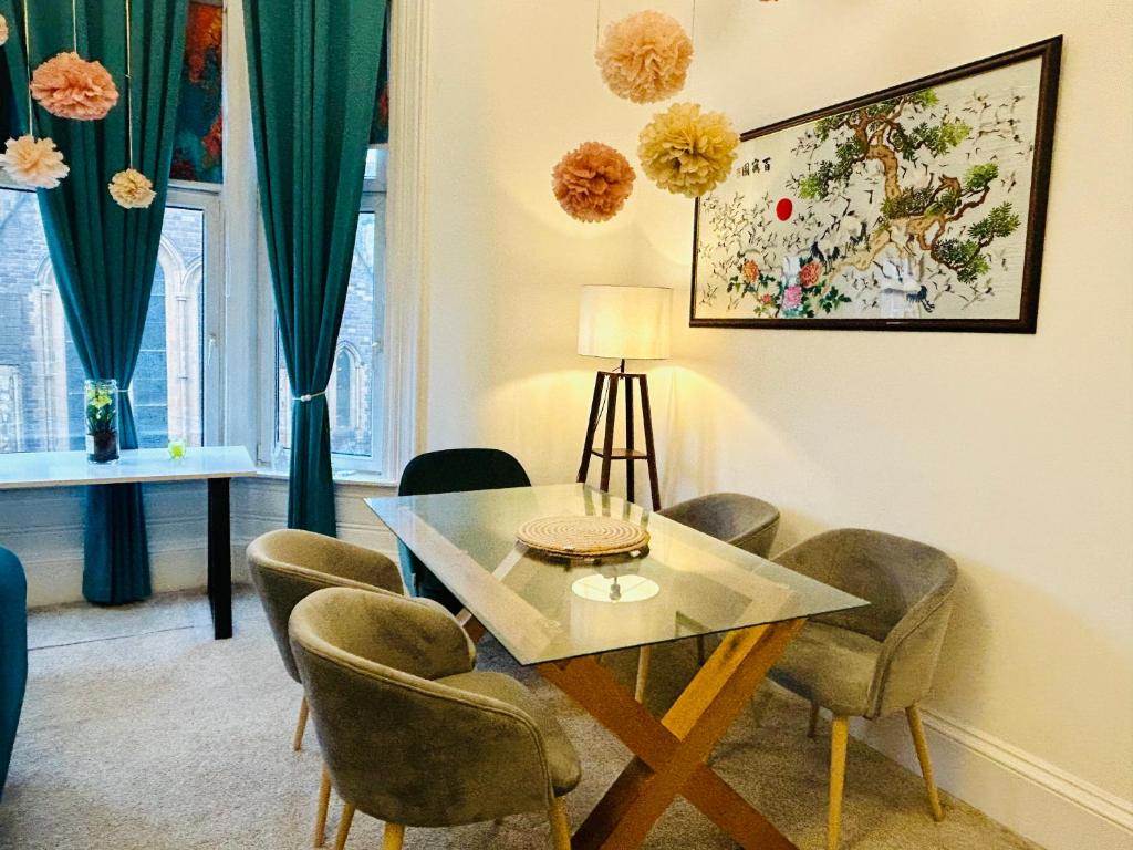 a dining room with a table and chairs at Glasgow Center/West End Apartment in Glasgow