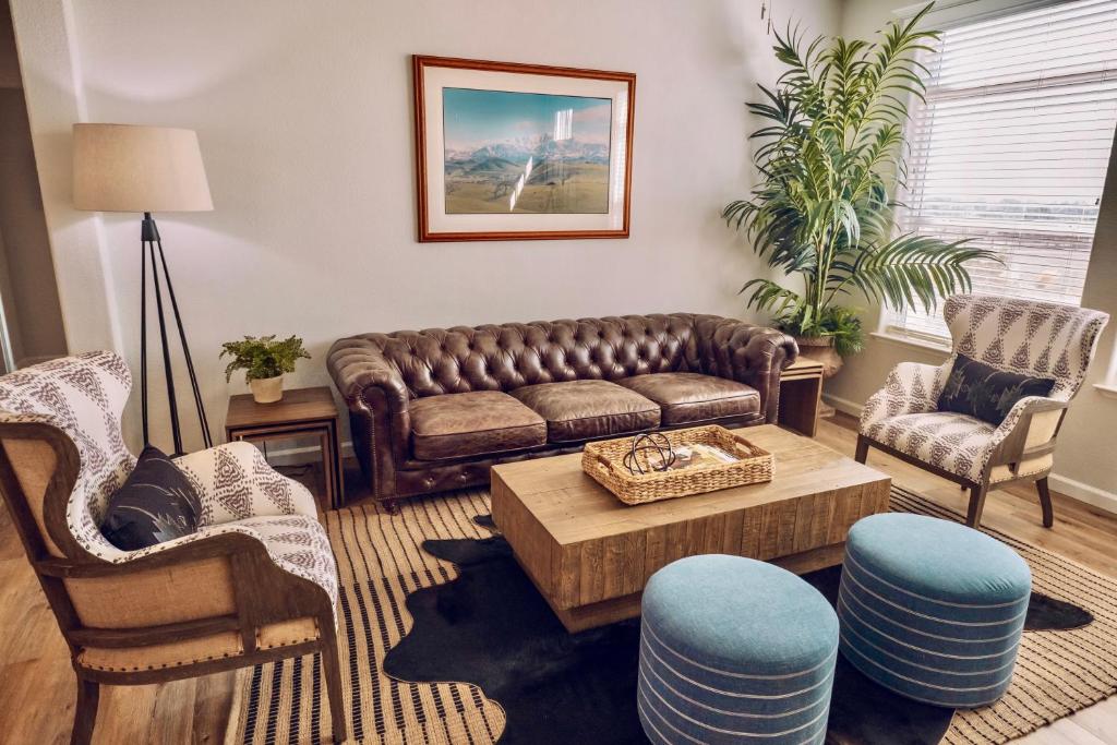 a living room with a couch and two chairs at Ranch House at Galway Downs in Temecula