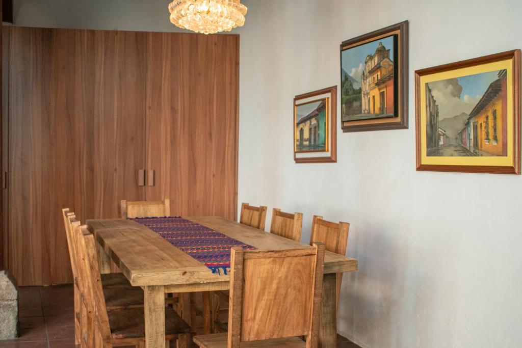 a dining room with a wooden table and chairs at 2 Pilas: historic colonial house in Antigua Guatemala