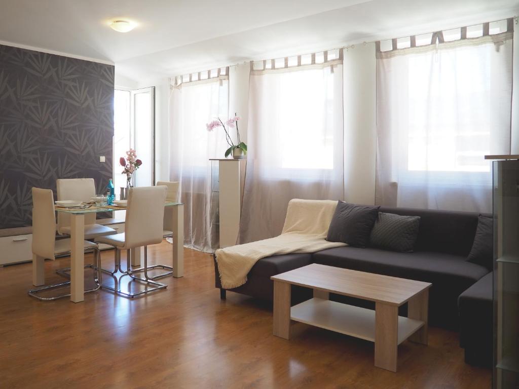 a living room with a couch and a table at Janka Apartment in Bratislava