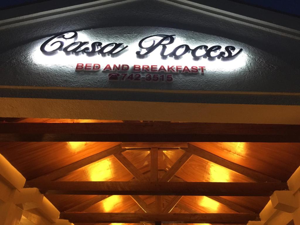 a sign for a red and breakfast restaurant on a ceiling at Casa Roces in Legazpi