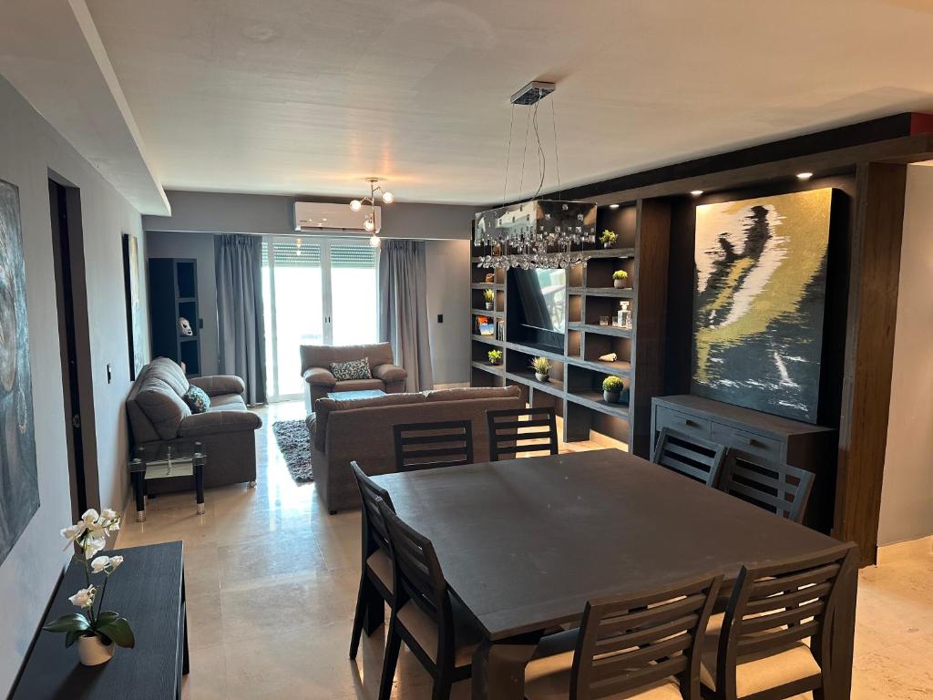 a living room with a table and a dining room at The Beach Residences in Puerto Morelos