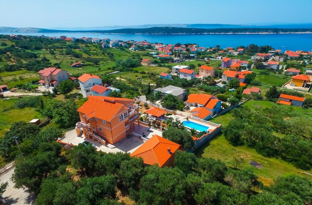 an aerial view of a house with an orange roof at Family-friendly apartments with swimming pool Banjol, Rab - 21952 in Banjol