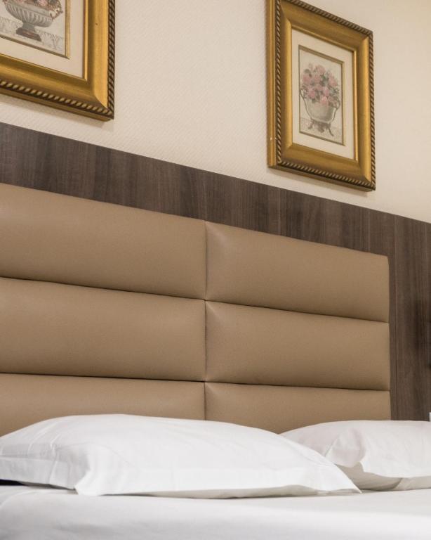 Postel nebo postele na pokoji v ubytování Hotel Monte Carlo