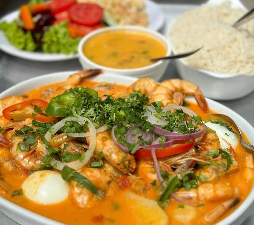 a plate of food with shrimp and other foods at Fazendinha Parque Raposa in Iguaíba