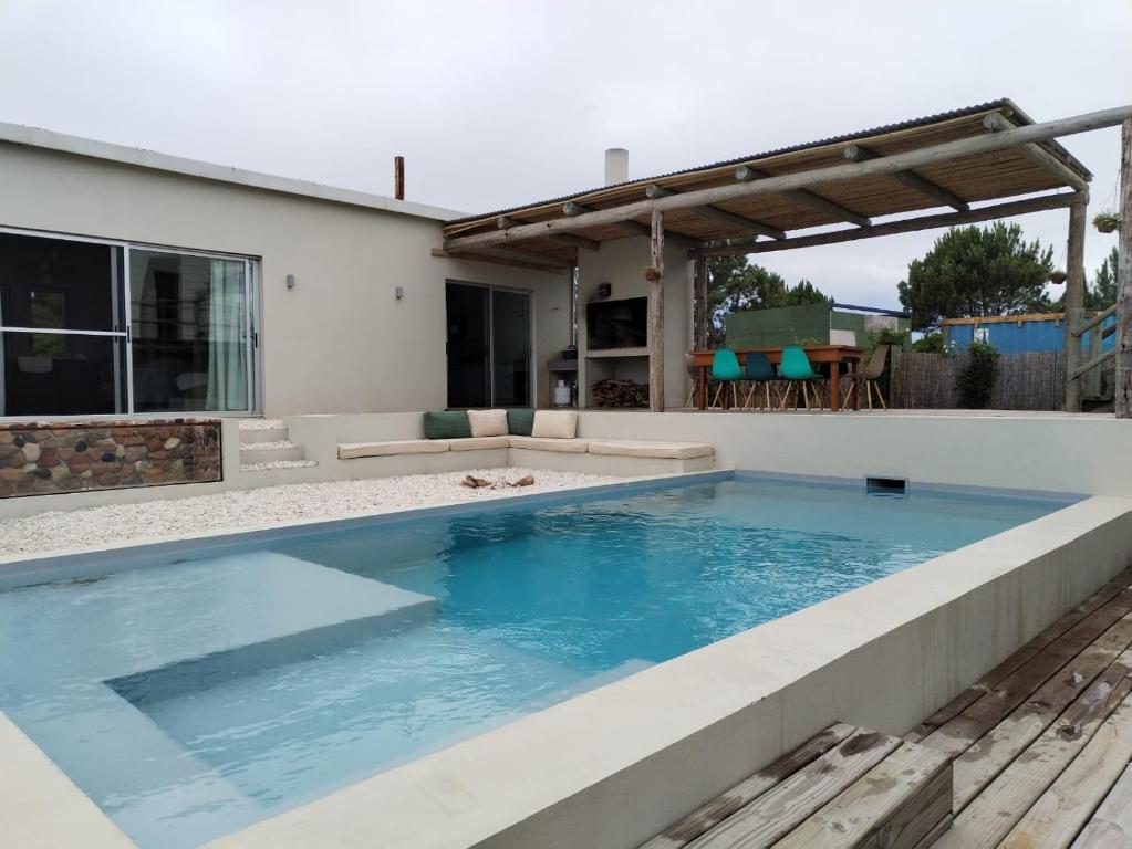 a swimming pool in the backyard of a house at Casa de playa en jose ignacio uruguay. in José Ignacio