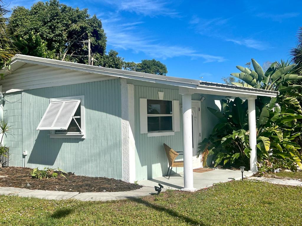 a small green house with a window and a fan at Retreat on the Island in Merritt Island