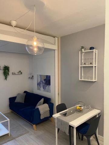 un salon avec un canapé bleu et une table dans l'établissement Charmant Studio 2P Montmartre, à Paris