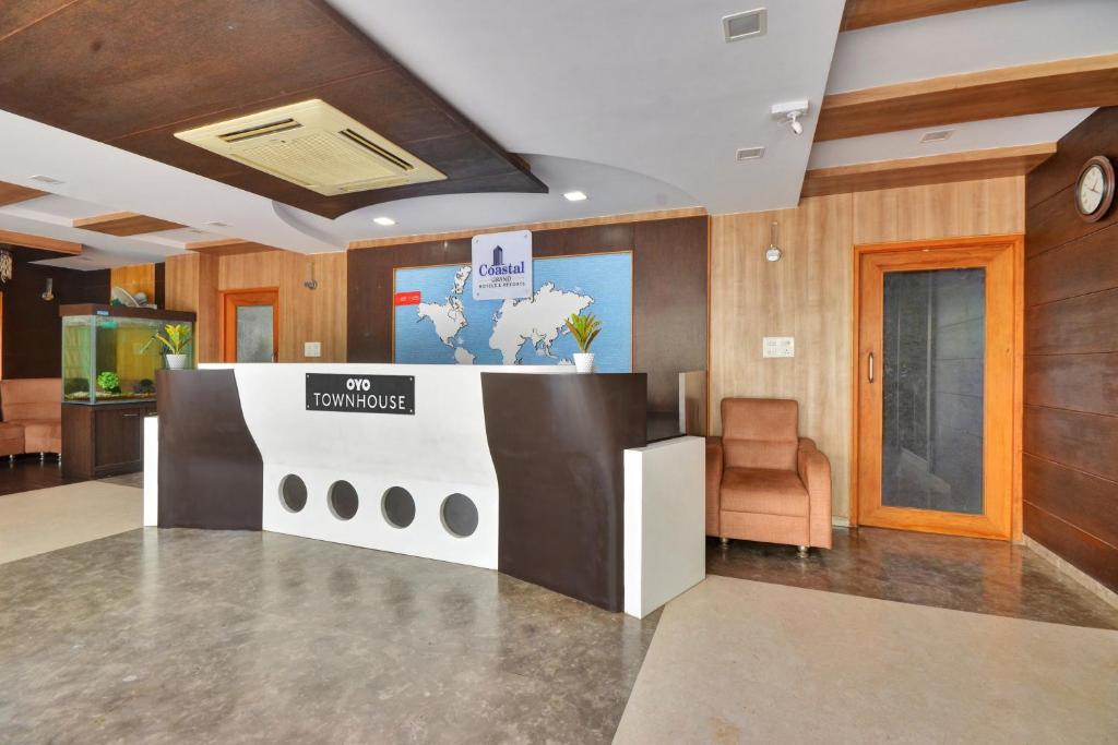 a lobby with a reception desk in a building at Townhouse 1307 Coastal Grand Hotels and Resorts in Coimbatore