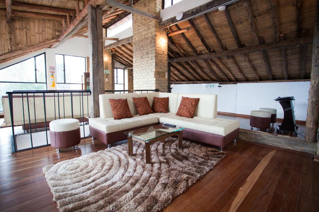 a living room with a couch and a rug at Arche Noah Boutique Hostel in Bogotá