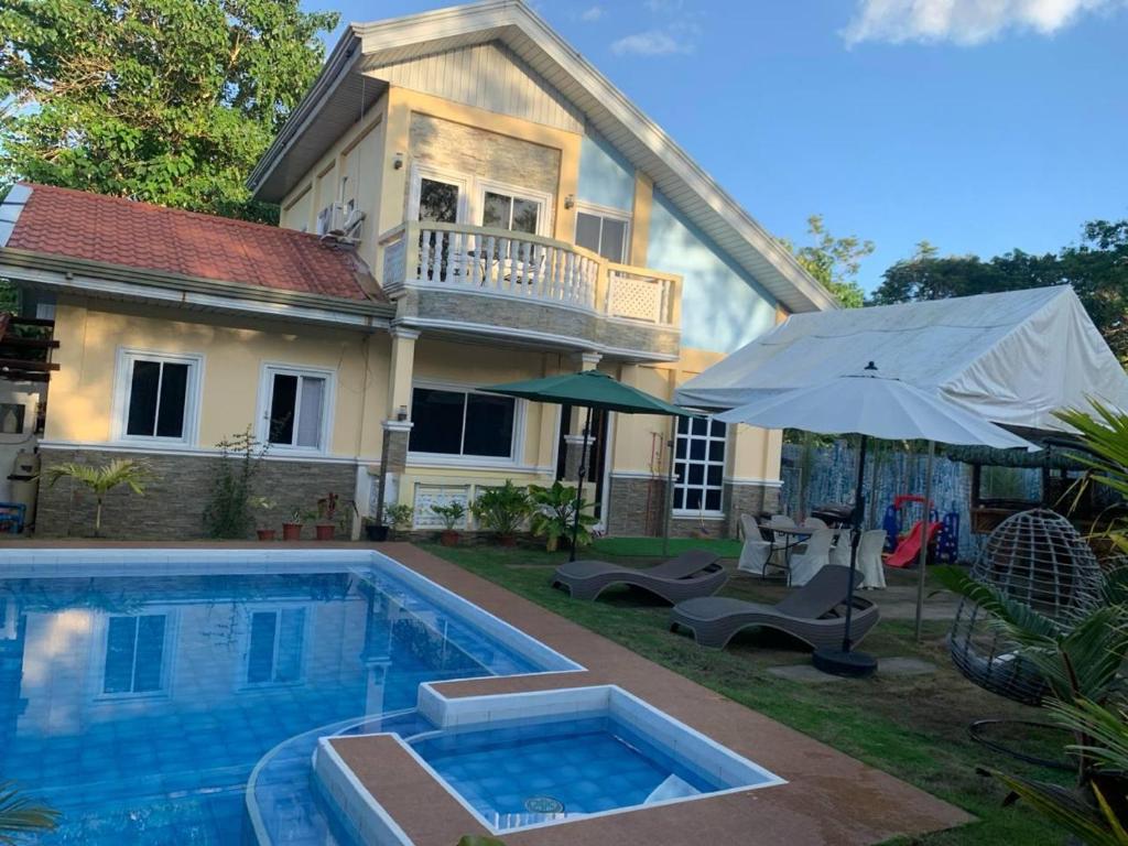 a house with a swimming pool in the yard at Paradise panglao pool villa 