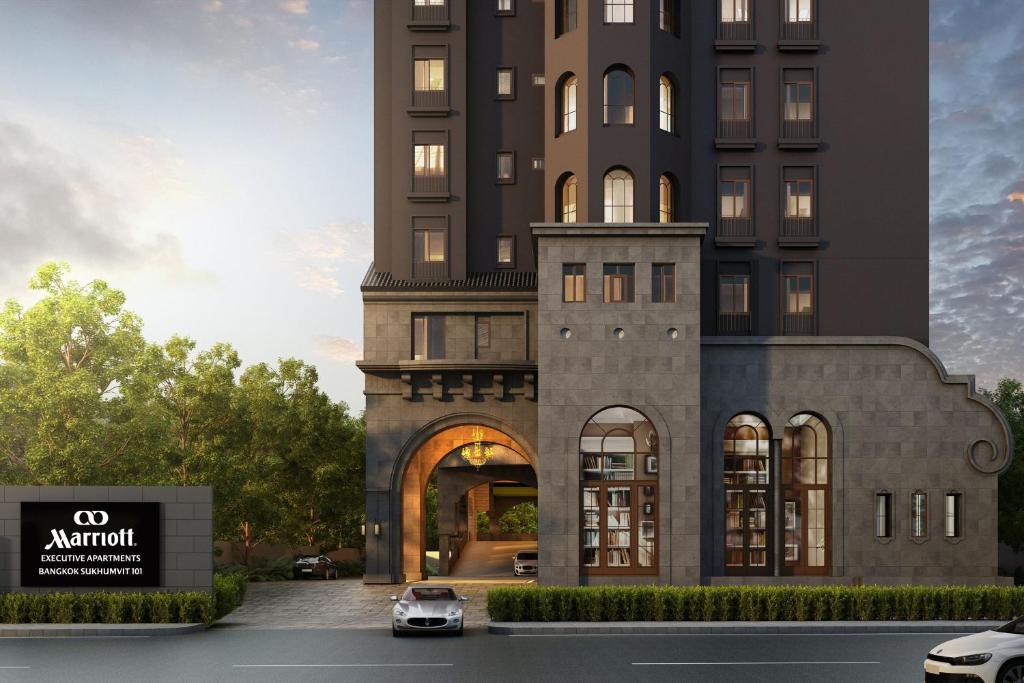a rendering of a building with a car parked in front at Marriott Executive Apartments Bangkok, Sukhumvit 101 in Bangkok