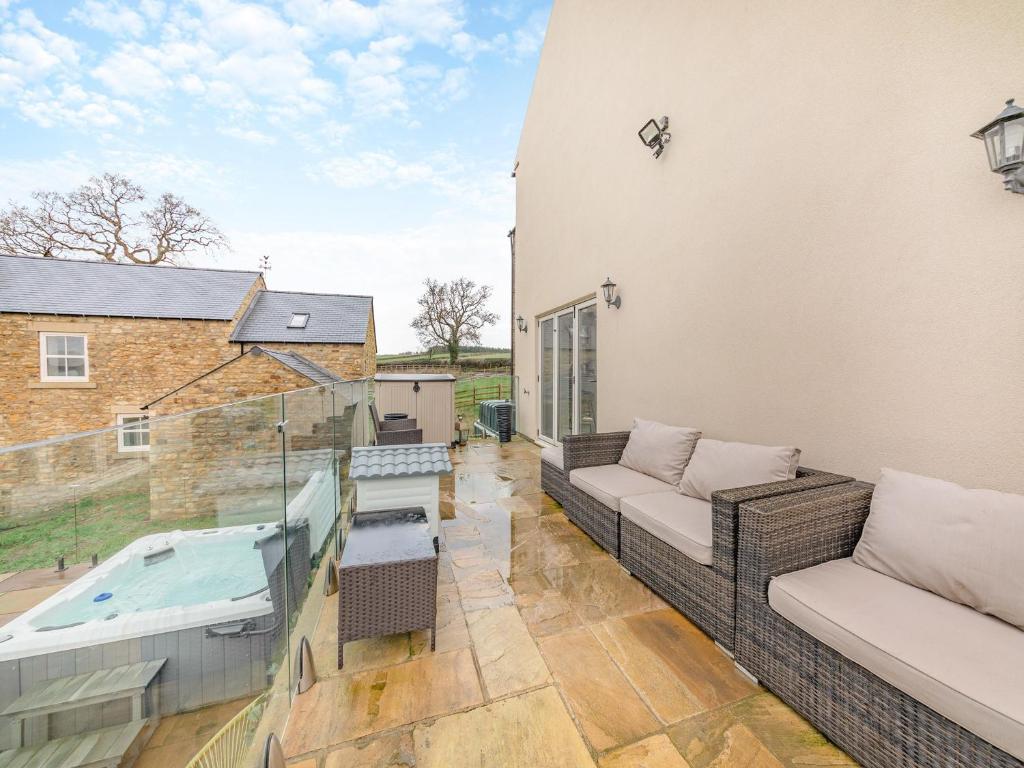 a balcony with a couch and a hot tub at Binchester Crag Farm in Bishop Auckland