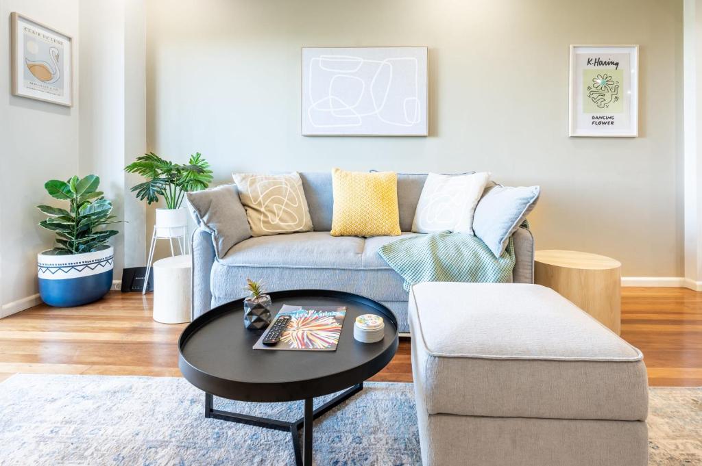 a living room with a couch and a table at Light Resort Style Haven in Darling Harbour in Sydney