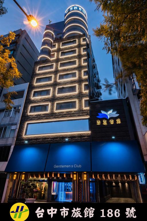 a tall building with a sign in front of it at 墨鐵會館 in Taichung