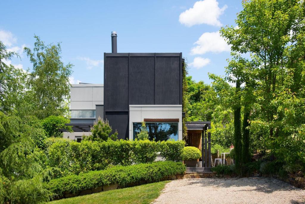 a house with a black and white facade at Harts Lane Stag and Millies in Daylesford