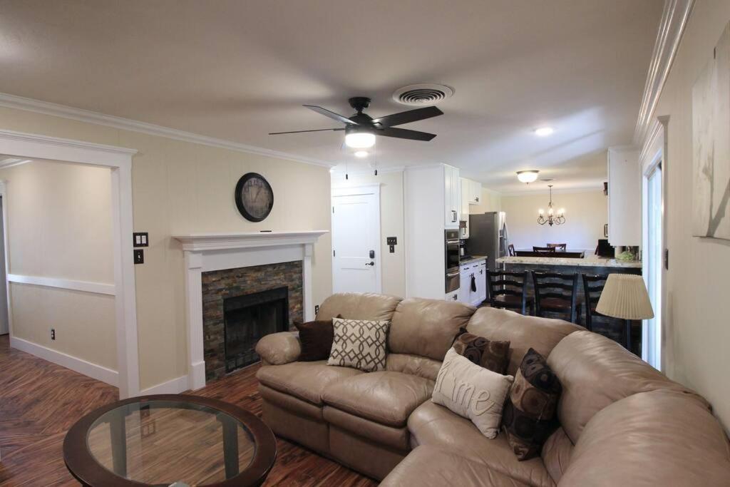 a living room with a couch and a fireplace at Cozy Aggieland Vacay in Bryan