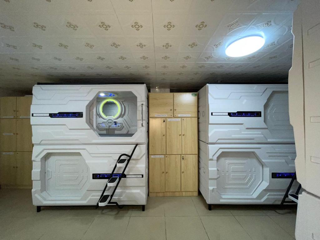 two washing machines in a room with a light at Efate Motel in Port Vila