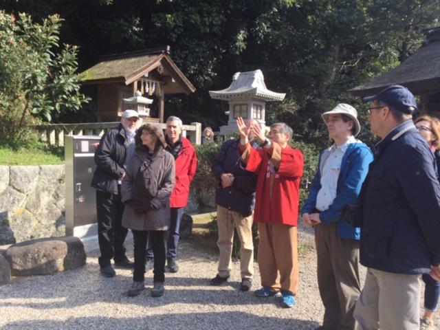 a group of people standing in front of a temple at Fukumakan in Matsue