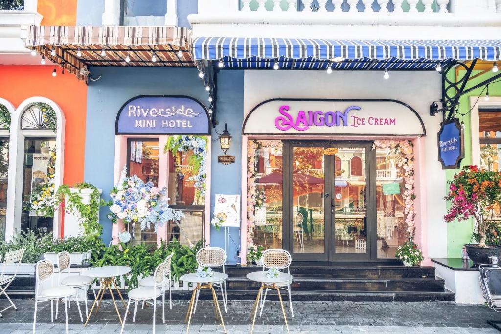 a group of tables and chairs outside of a store at Riverside Mini Hotel Grand World Phu Quoc in Phu Quoc