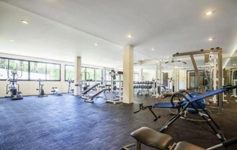 a gym with treadmills and machines in a room at Apartment in Ban Mae Nam