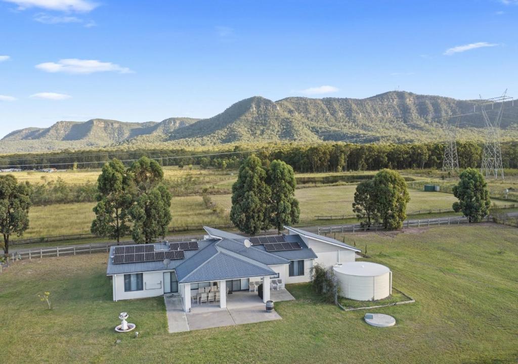 an aerial view of a house with mountains in the background at Horizon 7 in Pokolbin