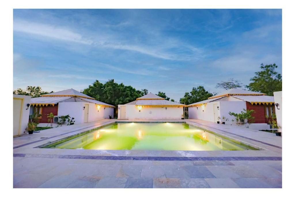 a swimming pool in the middle of a house at Aranya by Stories in Jaipur