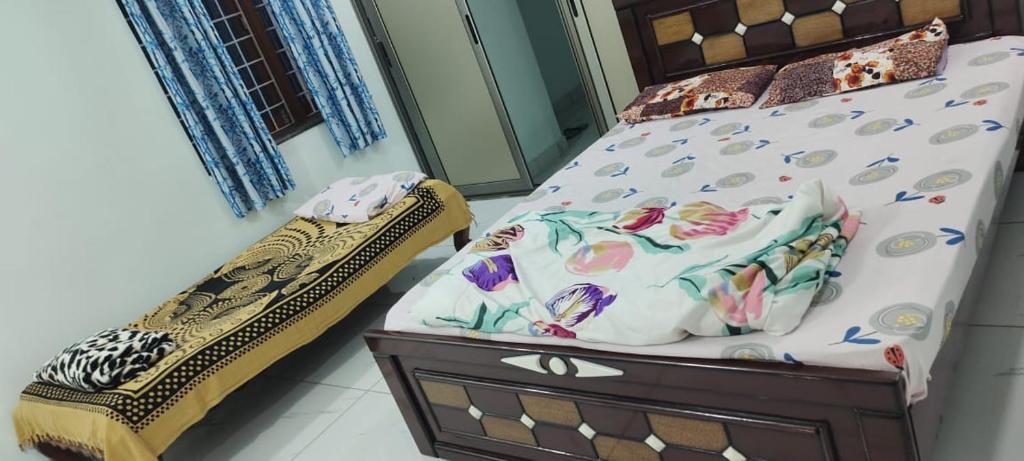 a bedroom with a bed with a wooden headboard at 4 KING SIZE BEDROOM DUPLEX VILLA in Hyderabad