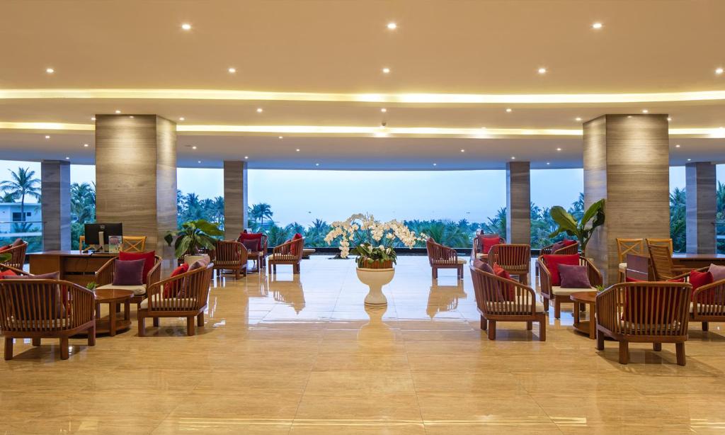 a lobby with chairs and tables in a building at Cam Ranh Riviera Beach Resort & Spa in Cam Ranh