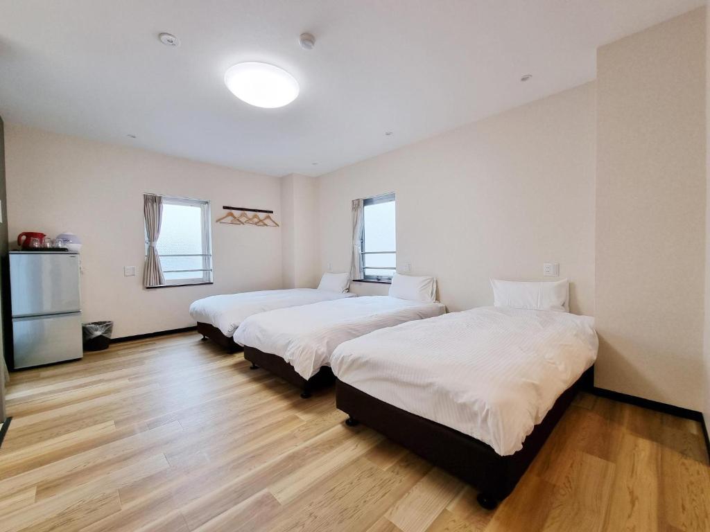 Posteľ alebo postele v izbe v ubytovaní KYU KYU HOTEL