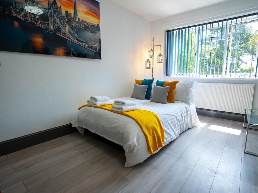 a bedroom with a bed and a large window at Contractors Wow3Beds off road Parking Town Centre in Farnborough