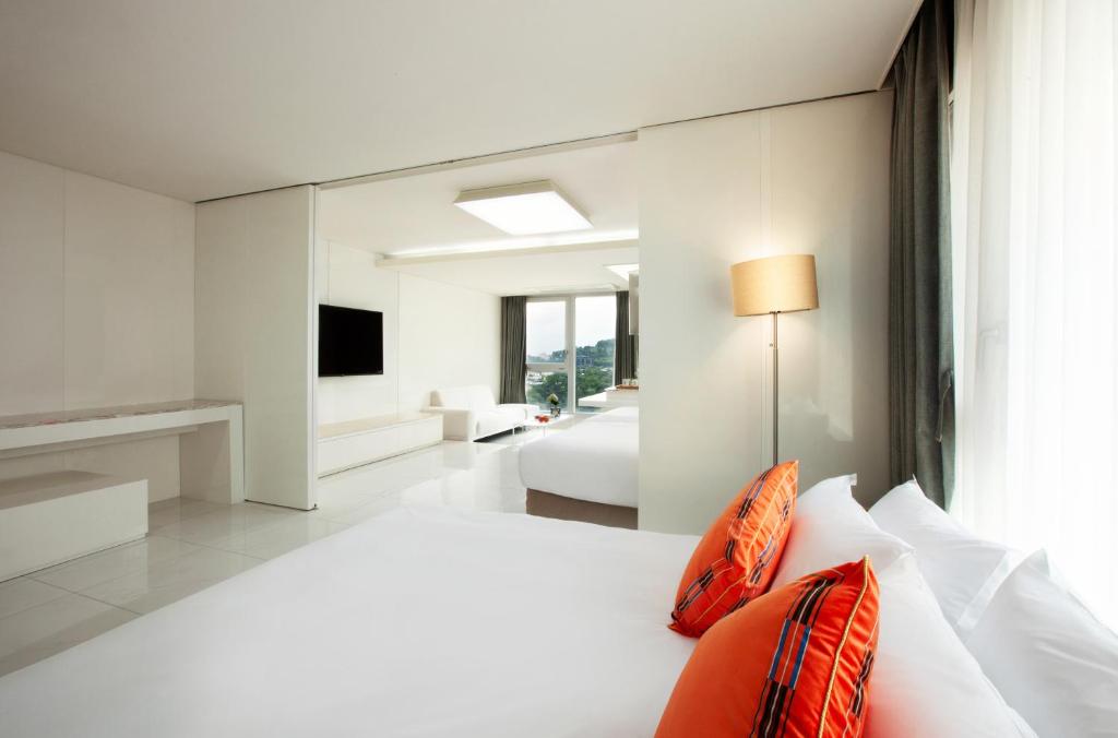 Postel nebo postele na pokoji v ubytování Shin Shin Hotel Jeju Ocean
