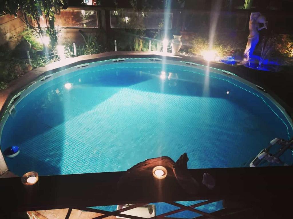 a swimming pool at night with lights around it at Remig Ranch in Challand Saint Victor