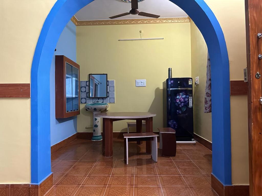 a room with a table and a sink and a mirror at VM Residency in Yelagiri