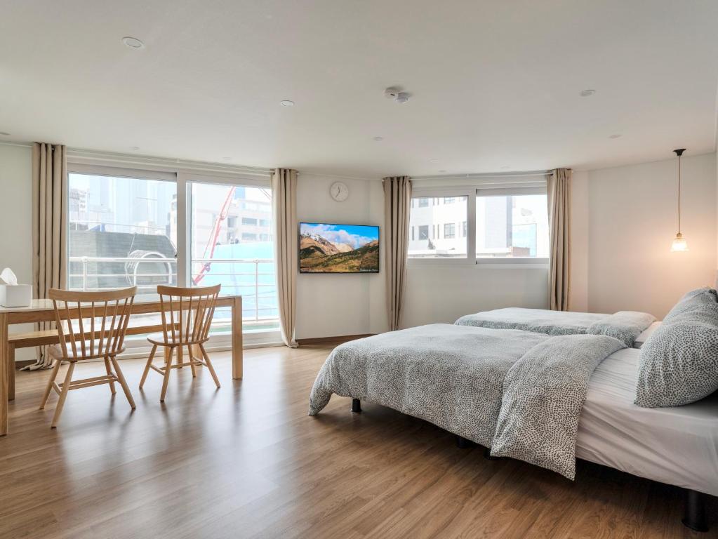 a bedroom with a bed and a table and chairs at Harmony Stay in Seoul