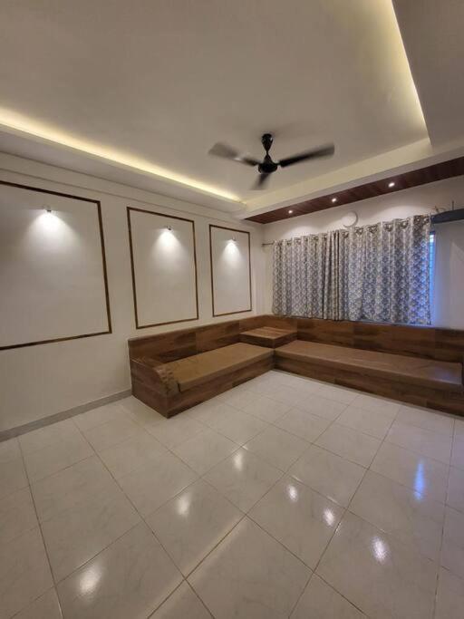 a living room with a couch and a ceiling at THE PERFECT STAYS : TRANQUIL VILLA in Lonavala